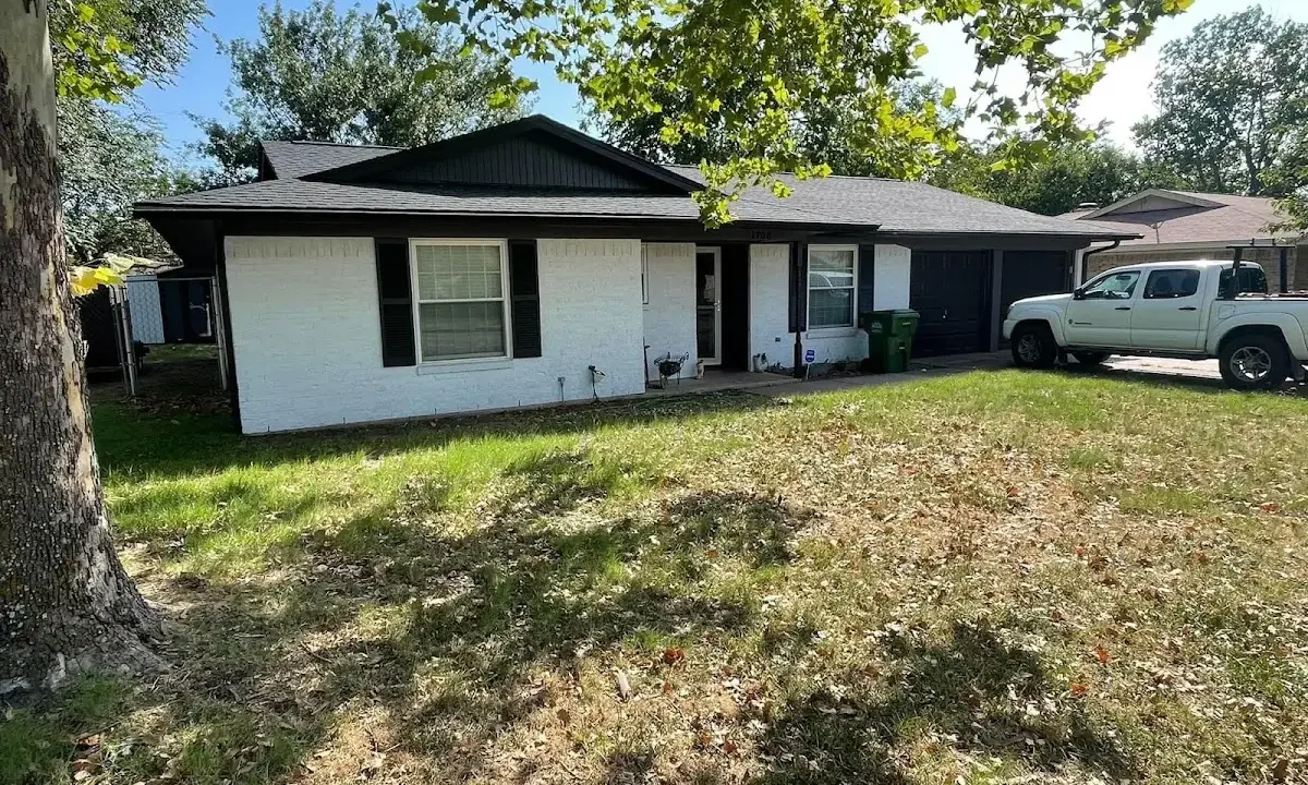Professional roofing crew working on a residential roof in New London